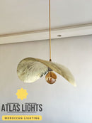 Pendant light fixture with marbled design on a white wall, featuring 'Atlas Lights' branding.
