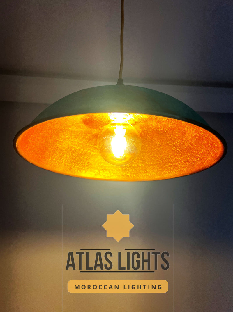 Pendant light with orange shade and visible Atlas Lights logo