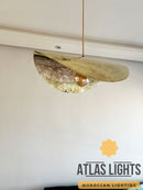 Gold pendant light fixture on a white ceiling with 'Atlas Lights' branding.
