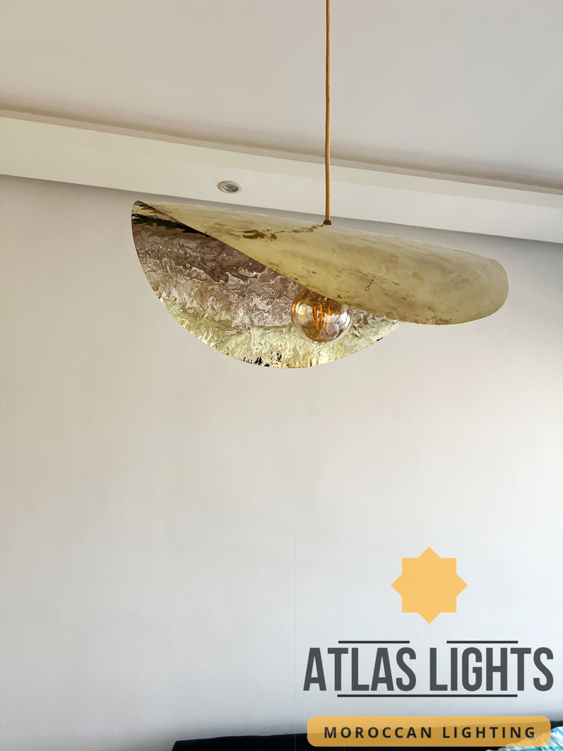 Gold pendant light fixture on a white ceiling with 'Atlas Lights' branding.