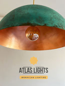 Hanging lamp with green and copper design, featuring Atlas Lights branding.