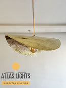 Hanging light fixture with natural wood and glass design, branded 'Atlas Lights'.