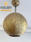 Decorative gold pendant light with intricate patterns on a white background, branded as Atlas Lights.