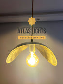 Pendant light with a glowing bulb, branded 'Atlas Lights' on a neutral background