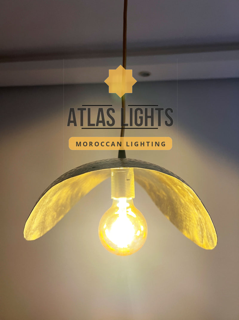 Pendant light with a glowing bulb, branded 'Atlas Lights' on a neutral background