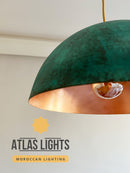 Green and copper pendant light with 'Atlas Lights' branding on a neutral background