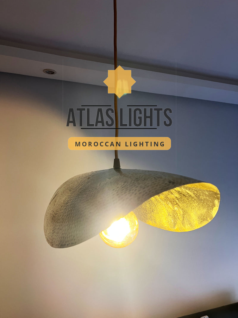 Pendant light with textured design on a neutral background, featuring 'Atlas Lights' branding.