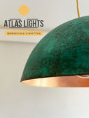 Green and copper pendant light with 'Atlas Lights' branding on a neutral background