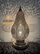 Decorative lamp with intricate patterns on a textured surface, branded 'Atlas Lights'.