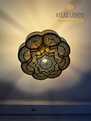 Handmade Moroccan brass ceiling lamp with geometric design. Adds luxury and warmth to your home. Available in gold, bronze, silver & black.
