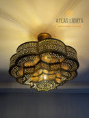 Handmade Moroccan brass ceiling lamp with geometric design. Adds luxury and warmth to your home. Available in gold, bronze, silver & black.