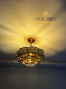 Decorative chandelier hanging from a ceiling with 'Atlas Lights' branding.