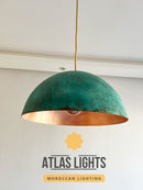 Green and copper pendant light with 'Atlas Lights' branding on a white background