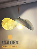 Modern pendant light with 'Atlas Lights' branding on a neutral background